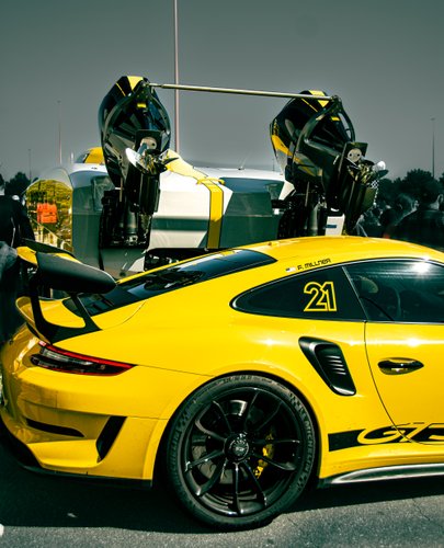 yellow porsche gt3 and yatch